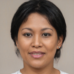 Joyful asian young-adult female with medium  brown hair and brown eyes