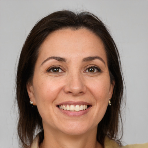 Joyful white adult female with medium  brown hair and brown eyes