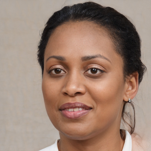 Joyful black young-adult female with medium  brown hair and brown eyes