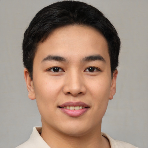 Joyful asian young-adult male with short  brown hair and brown eyes