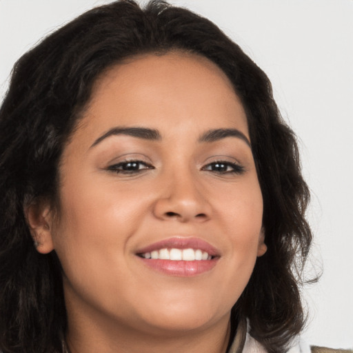 Joyful latino young-adult female with long  brown hair and brown eyes