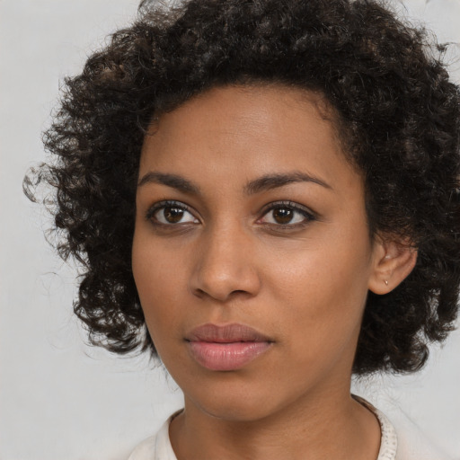 Neutral black young-adult female with medium  brown hair and brown eyes