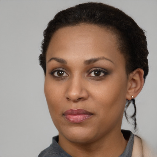Joyful black young-adult female with short  brown hair and brown eyes