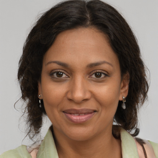 Joyful black young-adult female with medium  brown hair and brown eyes