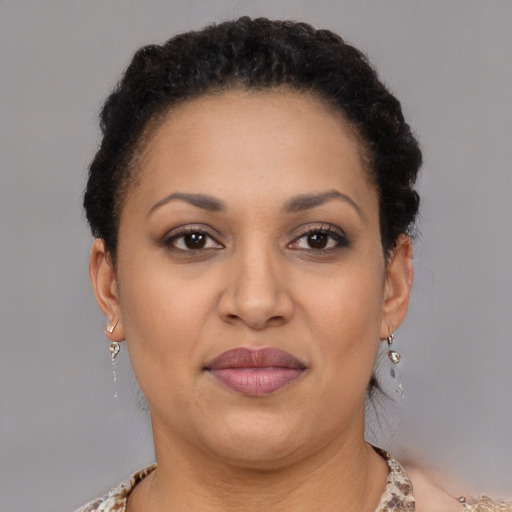 Joyful latino adult female with short  brown hair and brown eyes