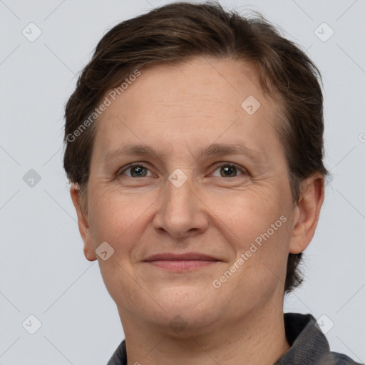 Joyful white adult female with short  brown hair and grey eyes