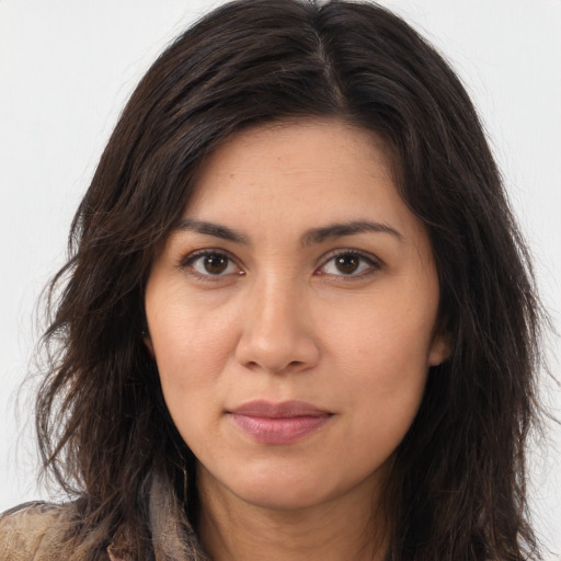 Joyful latino young-adult female with long  brown hair and brown eyes