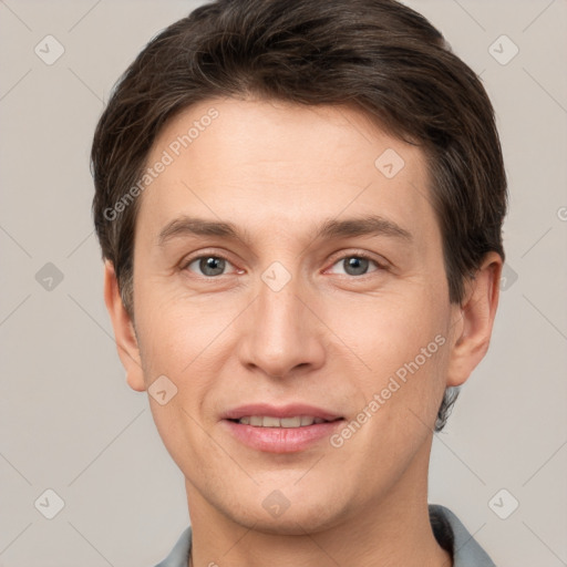 Joyful white adult male with short  brown hair and grey eyes