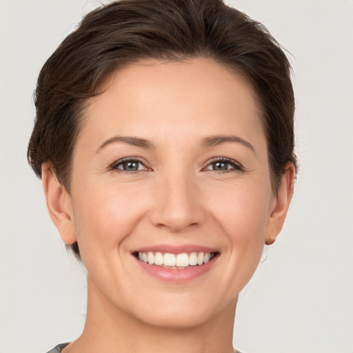 Joyful white young-adult female with short  brown hair and brown eyes