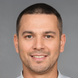 Joyful white young-adult male with short  brown hair and brown eyes