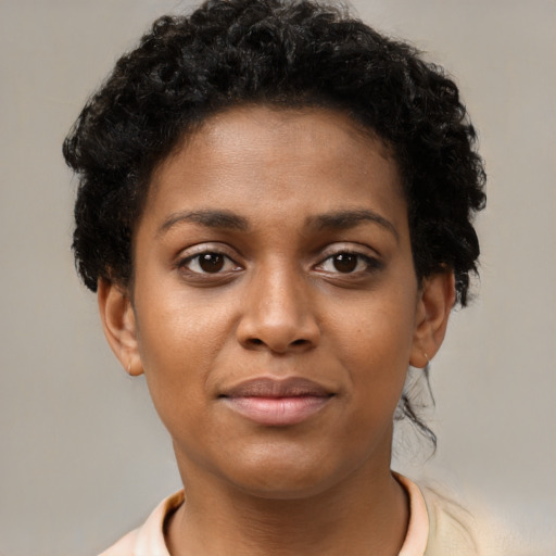 Joyful black young-adult female with short  brown hair and brown eyes