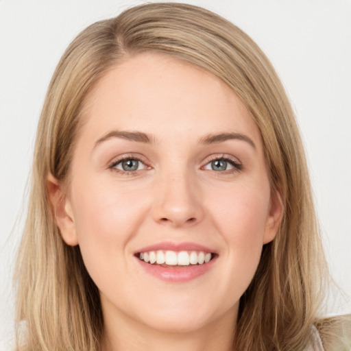 Joyful white young-adult female with long  brown hair and green eyes