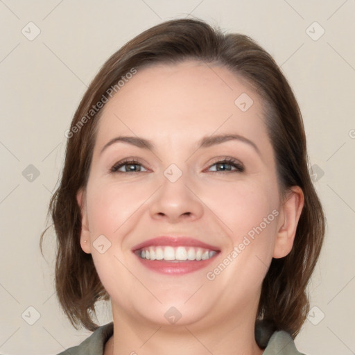 Joyful white young-adult female with medium  brown hair and blue eyes