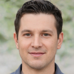 Joyful white young-adult male with short  brown hair and brown eyes