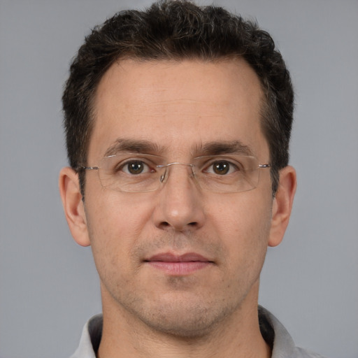 Joyful white adult male with short  brown hair and brown eyes