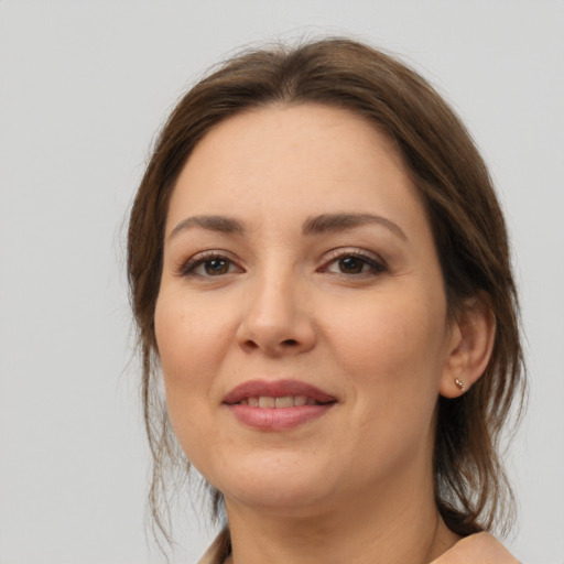 Joyful white young-adult female with medium  brown hair and brown eyes