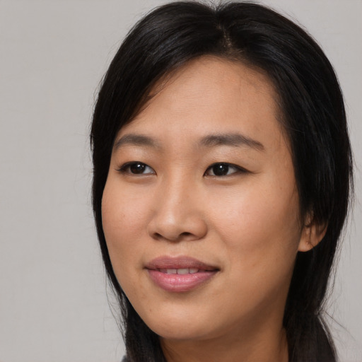 Joyful asian young-adult female with long  black hair and brown eyes