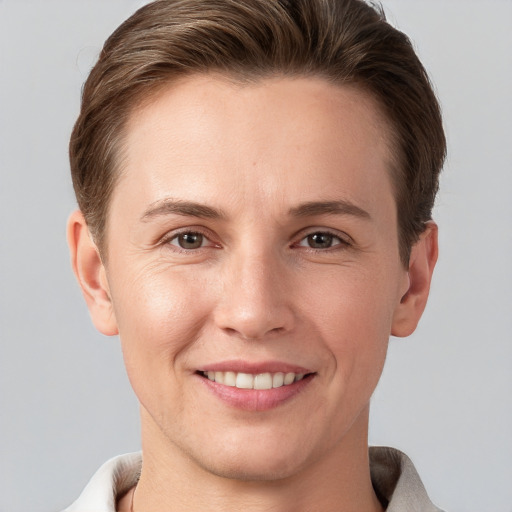 Joyful white young-adult female with short  brown hair and grey eyes