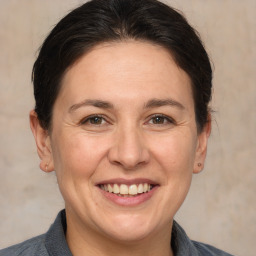 Joyful white adult female with medium  brown hair and brown eyes