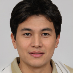 Joyful asian young-adult male with short  brown hair and brown eyes