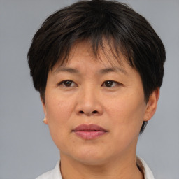 Joyful asian adult female with short  brown hair and brown eyes