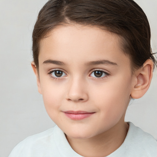 Joyful white child female with short  brown hair and brown eyes