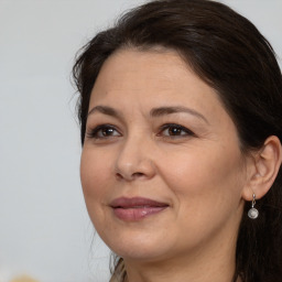 Joyful white adult female with long  brown hair and brown eyes