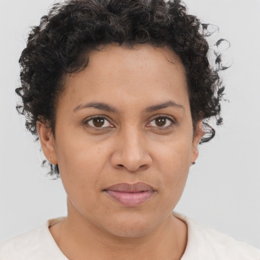 Joyful latino young-adult female with short  brown hair and brown eyes
