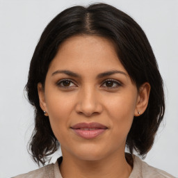 Joyful latino young-adult female with medium  brown hair and brown eyes