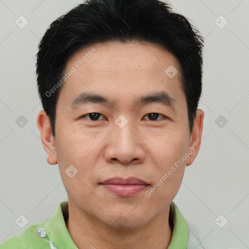 Joyful asian young-adult male with short  black hair and brown eyes