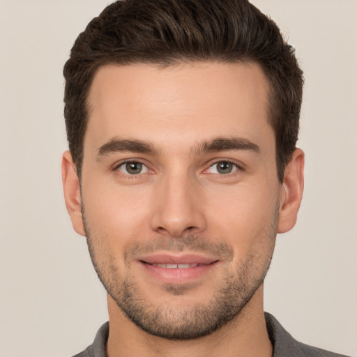 Joyful white young-adult male with short  brown hair and brown eyes