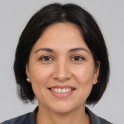 Joyful white adult female with medium  brown hair and brown eyes