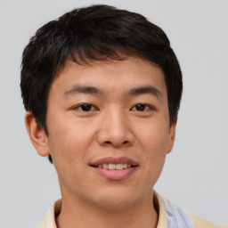 Joyful asian young-adult male with short  brown hair and brown eyes