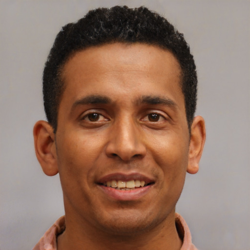Joyful latino young-adult male with short  brown hair and brown eyes