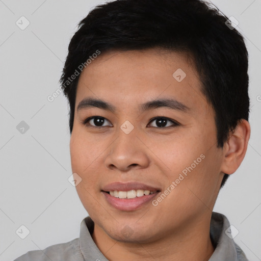 Joyful asian young-adult male with short  black hair and brown eyes