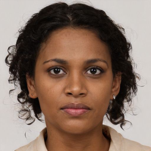 Neutral black young-adult female with medium  brown hair and brown eyes