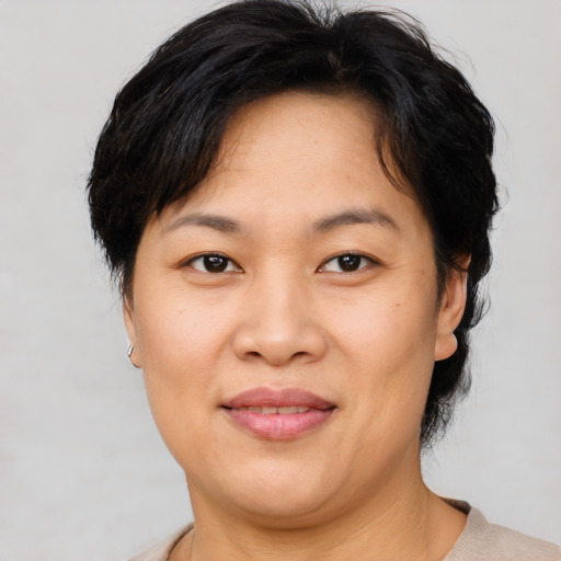 Joyful asian adult female with short  brown hair and brown eyes