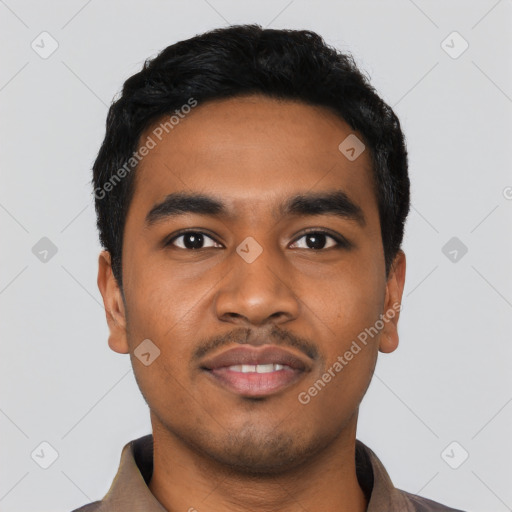 Joyful latino young-adult male with short  black hair and brown eyes