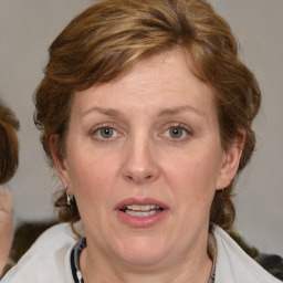 Joyful white adult female with medium  brown hair and blue eyes