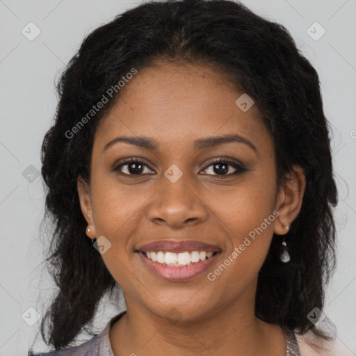 Joyful black young-adult female with long  brown hair and brown eyes