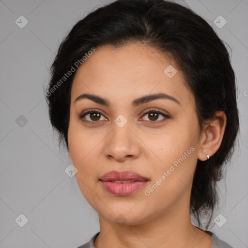 Joyful latino young-adult female with medium  brown hair and brown eyes