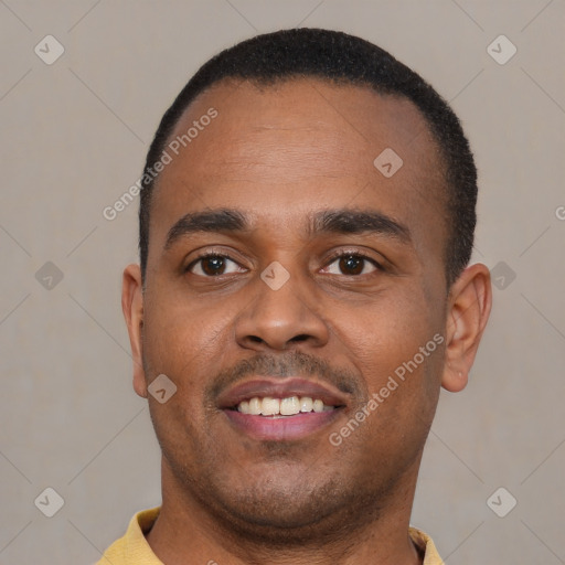 Joyful black young-adult male with short  black hair and brown eyes