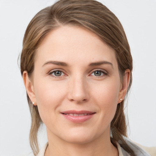 Joyful white young-adult female with medium  brown hair and grey eyes