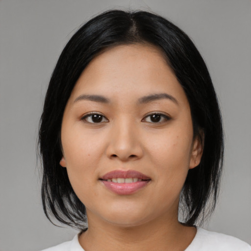 Joyful asian young-adult female with medium  black hair and brown eyes
