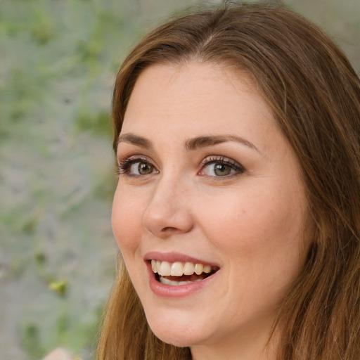 Joyful white young-adult female with long  brown hair and green eyes