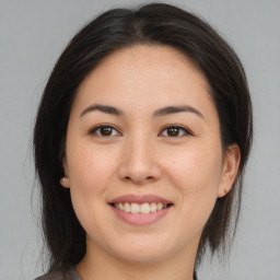 Joyful asian young-adult female with medium  brown hair and brown eyes