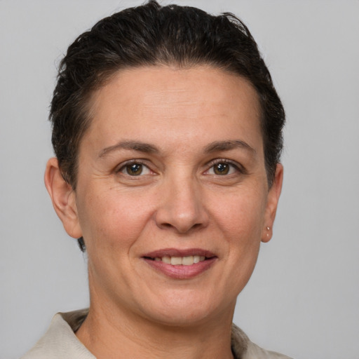 Joyful white adult female with short  brown hair and grey eyes