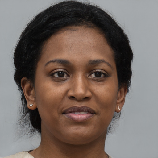 Joyful black young-adult female with medium  black hair and brown eyes