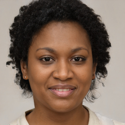 Joyful black young-adult female with medium  brown hair and brown eyes