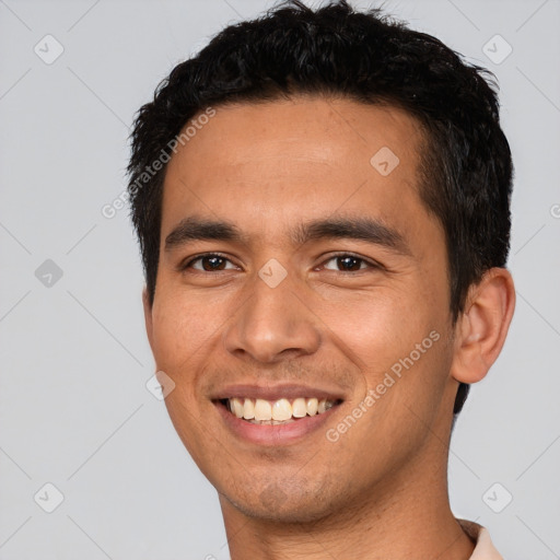 Joyful white young-adult male with short  black hair and brown eyes